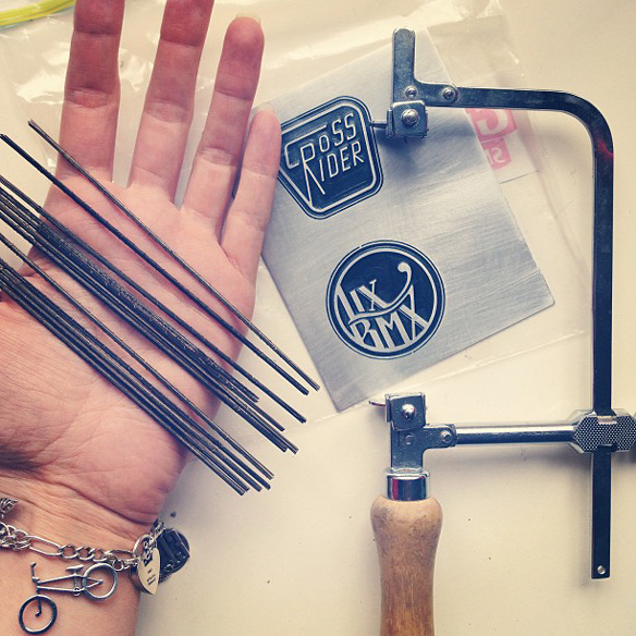 Custom engraved bike head tube badges ready to be cut out