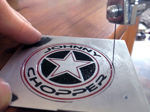 Cutting out the Johnny Chopper badge prototype 